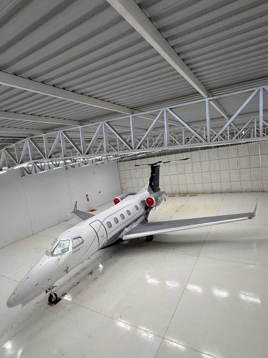 Premium modern private jet on a Bay Area hangar ramp at golden hour